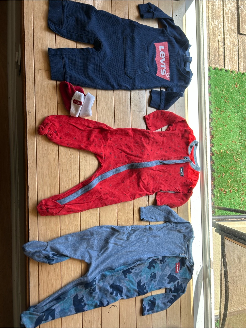 Lot of 4: 6mo Levi’s romper, 2 footie pajamas, 1 pair socks, Ralph Lauren romper